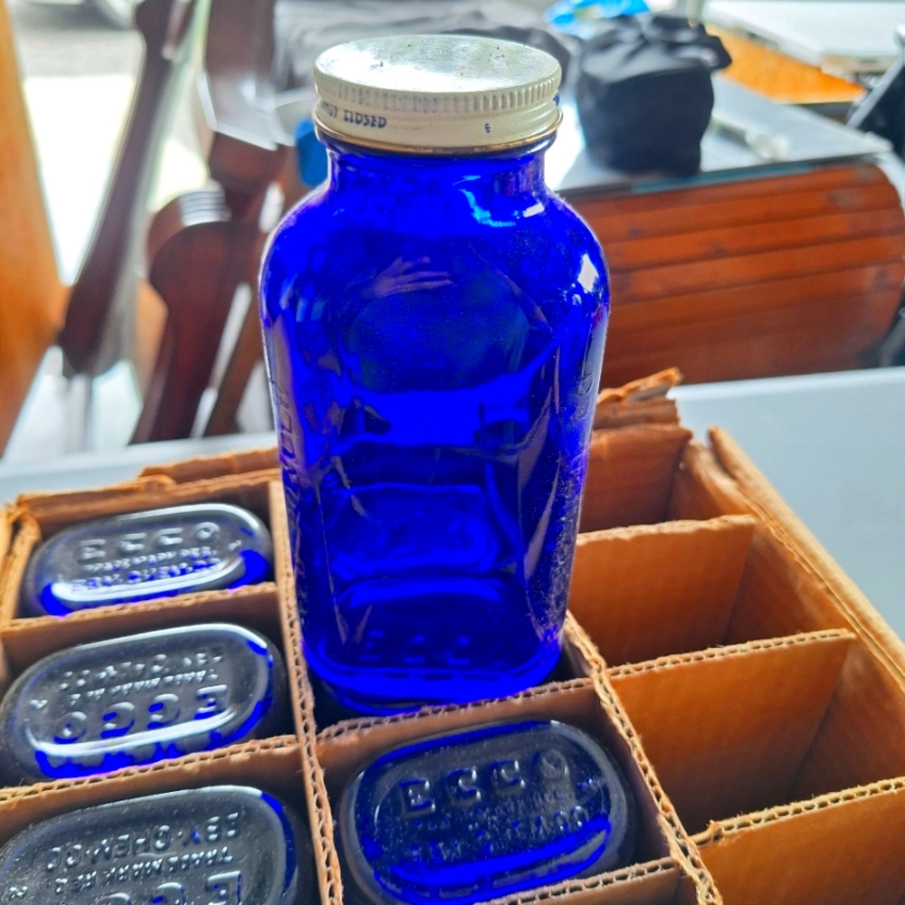 Ecco Vintage Cardboard Box with Cobalt Blue  Bottles.